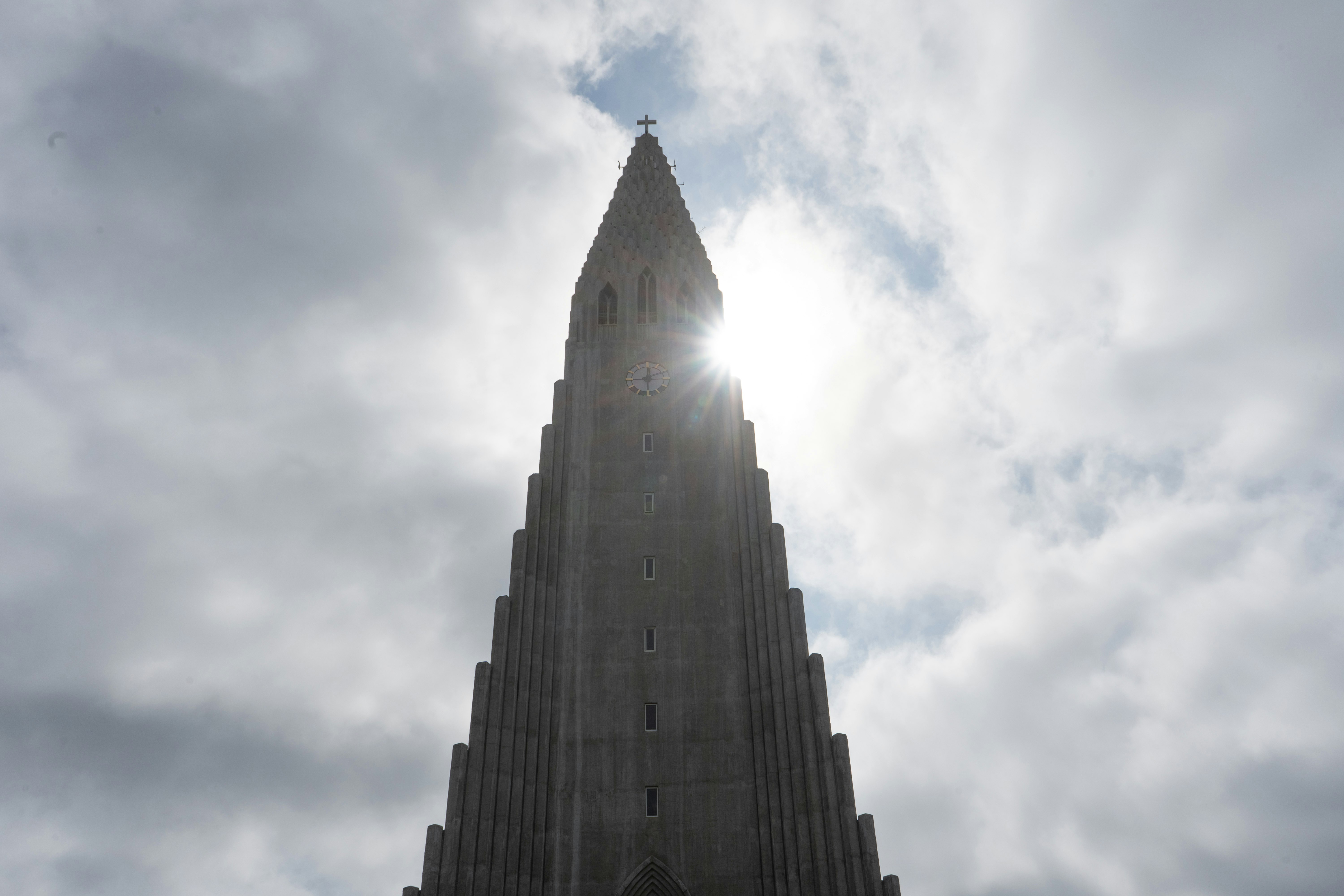 low angle photography of high rise building under white clouds during daytime